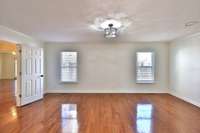 Den or formal sitting room toward windows/rear yard.
