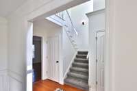 View from dining room toward front staircase. GOOD TO KNOW: The interior has been freshly painted throughout.