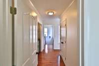 View toward back stairs, where you'll find a wet bar/coffee bar and a 50 sf storage closet with space for everything.