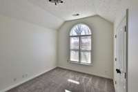Bedroom Two is 10.7x13.1 with a nicely angled ceiling and arched top window. New blinds, new light fixture, wide closet.