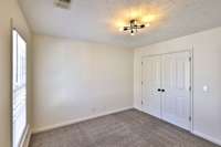 Bedroom Three is 11.9x10.11 and is at the top of stairs, features wide closet, new blinds, new light fixture.