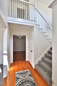 Light and bright entry foyer leads to dining room on left, den or formal living room straight ahead, and front stair way on right. There are TWO coat closets, one with extra hidden storage for seasonal decor.