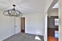 Dining room light fixture has been tied up but is correct length for dining table.