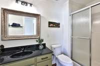 Third bath features a wide shower, elongated toilet.
