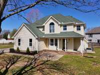 This four bedroom, three and a half bath home offers some charming surprises with a dramatic foyer, bay window, arched window, a few vaulted ceilings, stained glass inserts, and extensive storage.