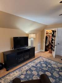 Walk-in closet in the bonus room with attic access.
