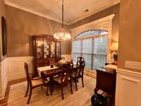 Formal dinning room with lots of natural lighting and custom trim.