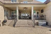 Step off the covered porch on this stamped concrete and stone patio.