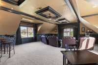This massive recreational room has windows on three sides. The sellers used this as a theater room.