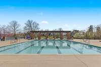 The community amenities include a large pool and recreational area.