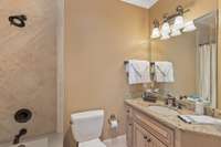 Tile shower surround, beautiful cabinet and granite counter tops in the attached bathroom.