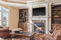 The keeping room has a gas fireplace flanked on either side by lovely built in bookcases that match the cabinetry of the kitchen.