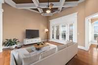 Coffered ceiling design in the main living room which has direct access to the covered porch. (room virtually staged)