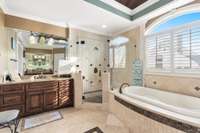 Dual separate vanities with granite countertops.