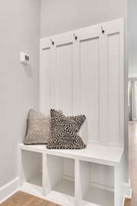 Stock Model Photo. Valet bench and hooks included with every home!