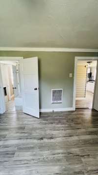 Gas heater installed in the bathroom & the bedroom on the rear of the home.  There is no cover for the heater in the bathroom.