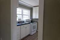 Kitchen comes with smooth top range, refrigerator and countertop microwave. Kitchen could easily be redesigned using the current materials provided.