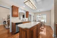 This kitchen has it all - from wood cabinets, prep island, stainless appliances, and pantry.