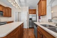 This kitchen has it all - from wood cabinets, prep island, stainless appliances, and pantry.