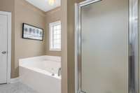 The primary ensuite features double vanities, soaking tub and walk-in shower plus separate toilet area and walk-in closet.