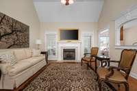 Open layout living room flows to the kitchen. Featuring tall, vaulted ceilings and gas fireplace.