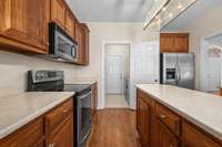 This kitchen has it all - from wood cabinets, prep island, stainless appliances, and pantry.