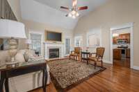 Open layout living room flows to the kitchen. Featuring tall, vaulted ceilings and gas fireplace.