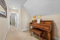 Spacious hallway has room for numerous uses, like a piano nook.