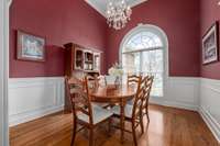 Formal dining room has great light, wainscoting detail trim and crystal chandelier. Could also be used as an office.