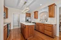 This kitchen has it all - from wood cabinets, prep island, stainless appliances, and pantry.