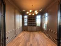 Private Study with custom built-in cabinetry, floor to ceiling wood detail on all walls and designer decorative lighting.
Photo taken 11/16/25