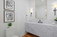 The powder room located in between the formal living and dining.
