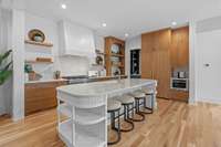 The backsplash has such character as well as the ends of the island. Open shelving with the ribbed top row in the cabinet.