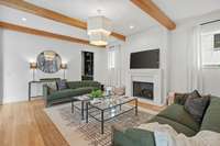 This is the formal living room. No detail overlooked. The beams to the fireplace surround gives this room warmth and sophistication.
