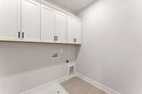 Laundry Room with Cabinet Storage. Photo is of actual Home.