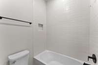 Tiled Shower with Tub in Secondary Bath. Photo is of actual Home.
