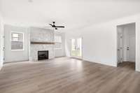 stone fireplace to the ceiling with cedar mantle