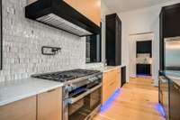Pot Filler / Double Miele Oven with 6 gas burners and griddle cooking space.