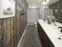 Full bath upstairs with double vanities and tub/shower combination