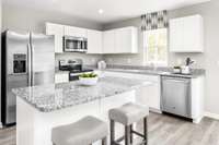 Bright white kitchen, granite countertops, and INCLUDED stainless steel appliances. Kitchen island is OPTIONAL. Kitchen dimensions : 10’7” x 11’5”
