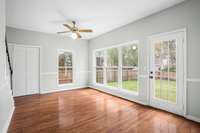 Family Room with view of large Privacy Fenced Back Yard, steps to the upper level and Laundry Room