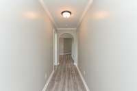 Hallway from 3rd bedroom to living room. (Vacant Photo shown is from 2023, prior to the current owner’s purchase)