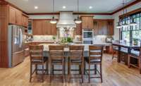The chef's kitchen is sure to delight. The breakfast nook overlooks the backyard, with four large windows with retractable screen shades.