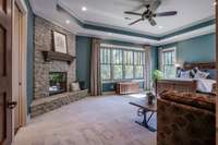 The stacked-stoned fireplace with a wood mantle highlights this lovely room.