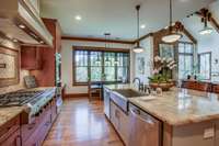 The large kitchen features a 48” gas cooktop w/ six burners, pot filler, high-end appliances,  two dishwashers, and a large refrigerator, giving cooks everything needed to create culinary delights.