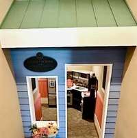 The playhouse hidden under the stairs adds a whimsical touch that welcomes guests of all ages.