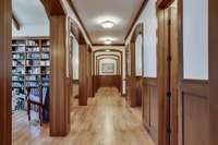 The great hallway has extensive, trimmed hardwood arches connecting to several of the main rooms. Also serves as an art gallery.