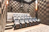 18-seat cinema features terraced leather rockers, 12’ wide-high contrast screen w/masking for multiple aspect ratio films, surround speakers, QSC speakers behind the screen, subwoofers, acoustic tiled walls, copper sconces & dimmable step lights.