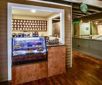 You guessed it!  A coffee shop to serve up cappachinos, lattes, and espresso. Granite counters, a stainless steel sink, plentiful storage, and a rolling supply metal shelf for storing extra supplies.