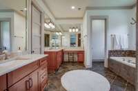 The primary bath is a sanctuary with luxury and privacy in mind. Adjacent is an extra large, well-designed walk-in closet with exceptional closet organization and a built-in mini refrigerator.